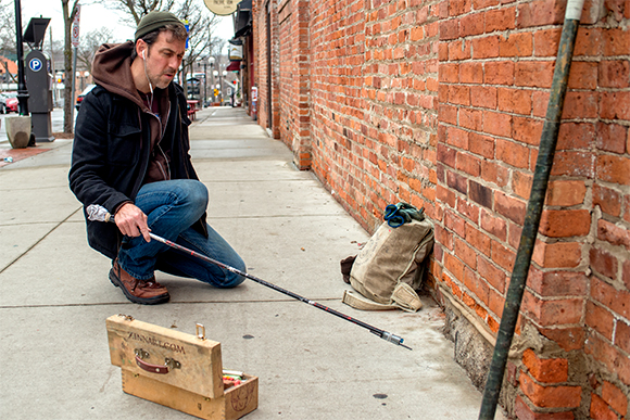 David Zinn starts a chalk drawing on West Liberty