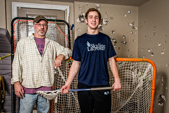 Steven Gillis with his son Zach Schwartz practicng lacrosse