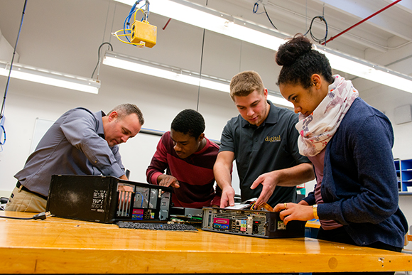 L to R Jack Bidlack, Howard Williams, Ryan Dixon and Sina Webster working on computers for Digital Inclusion