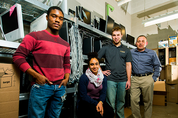 L to R Howard Williams, Sina Webster, Ryan Dixon and Jack Bidlack in the Digital Inclusion storeroom