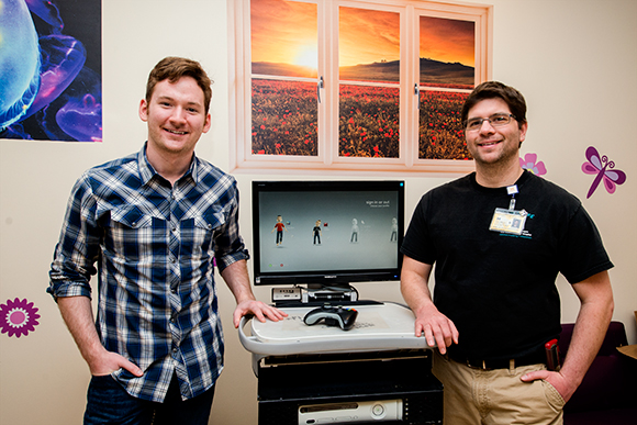 L to R Zach Wigal and Child Life Specialist Jean-Jacques Bouchard with a first generation GO Kart at CS Mott Children's Hospital 