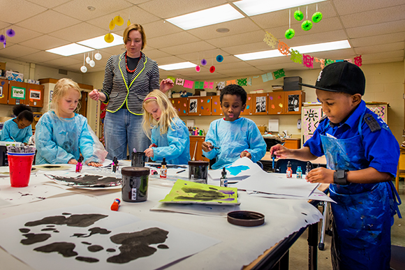 Allida Warn helping kids with art projects at Erickson Elementary
