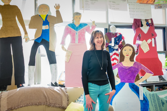 STEAM @ Northside fifth-grade teacher Cindy Johengen with some of her students' work from the Revolutionary War history studies