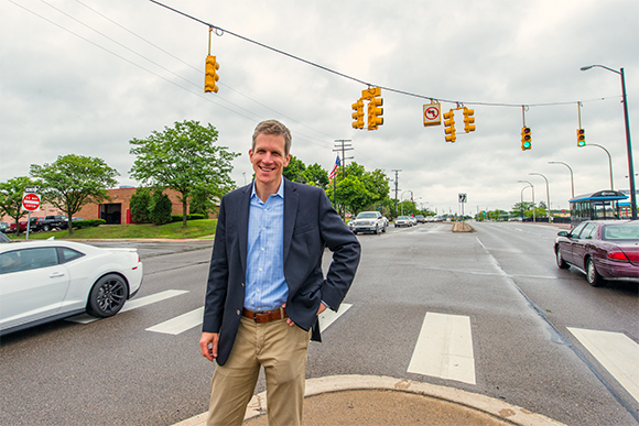 Kirk Westphal standing in the median of Washtenaw by Arborland Mall