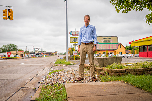 Kirk Westphal at one of the many gaps in the sidewalk on Washtenaw