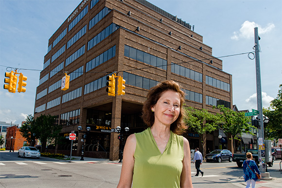 Susan Pollay in front of one Ann Arbor's newest office buildings - from almost 30 years ago