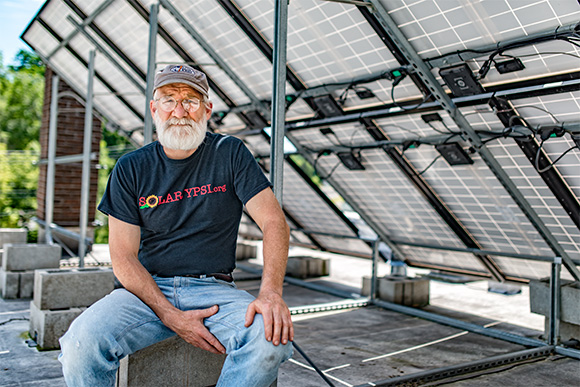 Dave Strenski with the solar panels at the Ypsilanti Food Coop