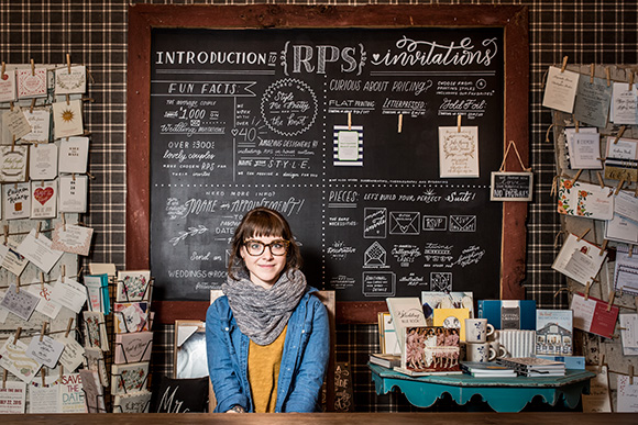 Kristen Drozdowski with one of her chalkboard displays at Rock Paper Scissors