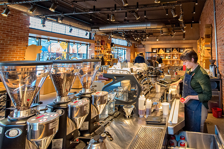 Erica Perry making a latte at Shinola Cafe