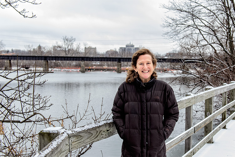 Huron River Watershed Council executive director Laura Rubin by the Huron River in Ann Arbor