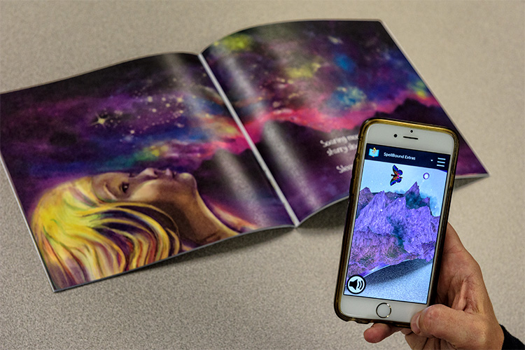 Spellbound CEO Christina York demonstrating the AR with the book Sleep Sweet