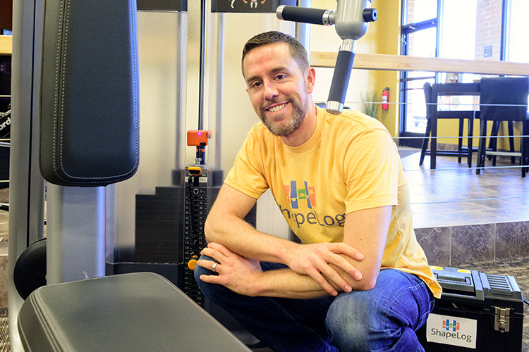 Brian Hayden of ShapeLog with a Universal Strength Tracker on a weight lifting machine