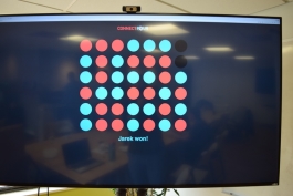 A display shows a game of Connect Four at the Atomic Games.