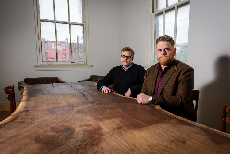 Mark Maynard and Jesse Kranyak at Landline Creative Labs' conference table, which was built by their downstairs neighbor.