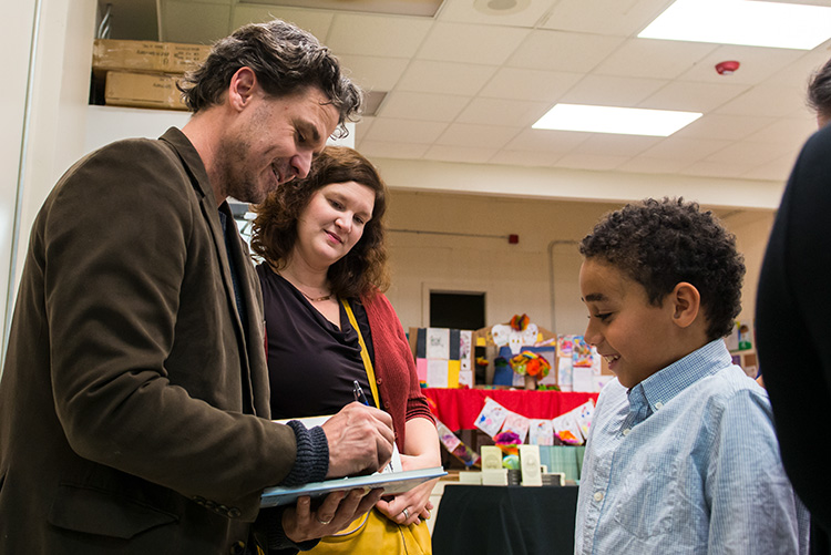 Dave Eggers and Amanda Uhle of 826michigan with a student at the Boggs School in Detroit