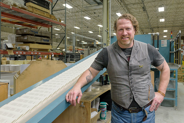 Kevin Spall with books coming off the printing presses at Thomson-Shore