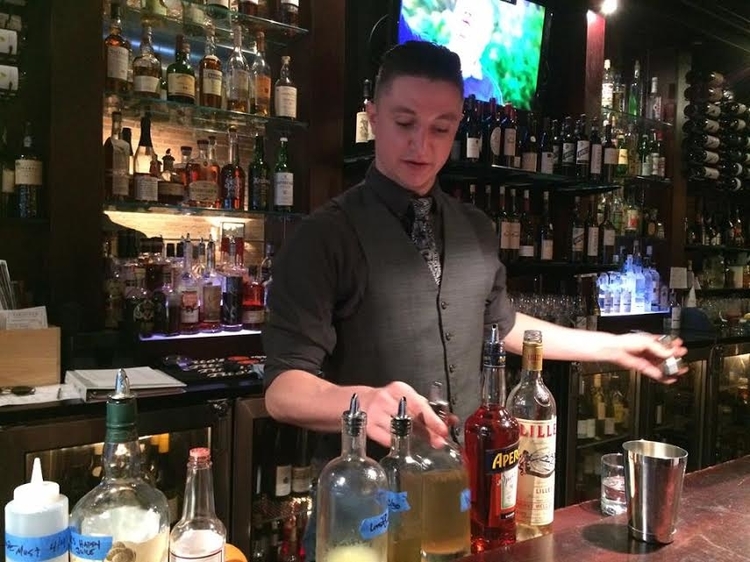 New head bartender Ian Youngs behind the bar at Vinology.