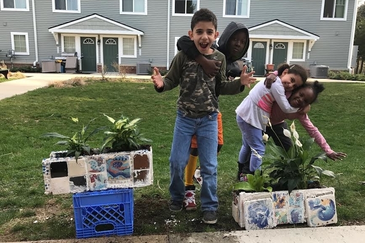 Community Action Network students work on living wall mosaics.