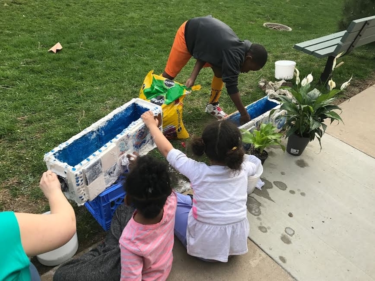 Community Action Network students work on living wall mosaics.