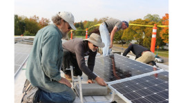 Solar panel installation in progress atop Ypsi's fire station.