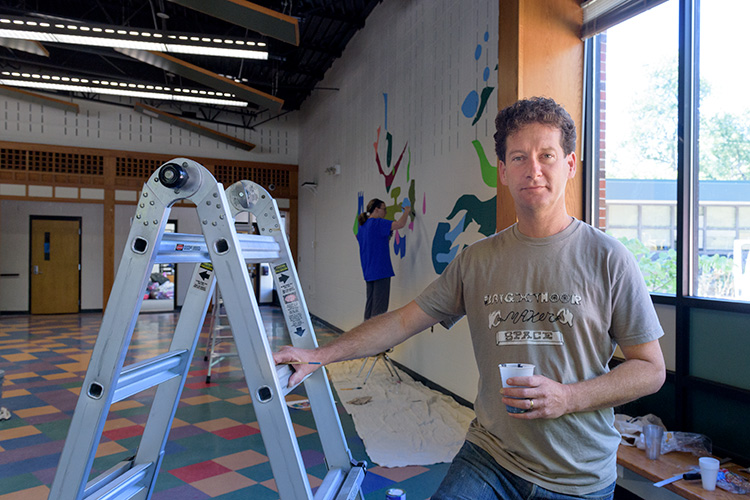 Nick Tobier painting murals at Bach Elementary School in Ann Arbor