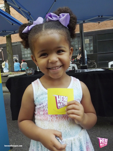 A young visitor to Hero Nation's booth at Ypsi Pride.