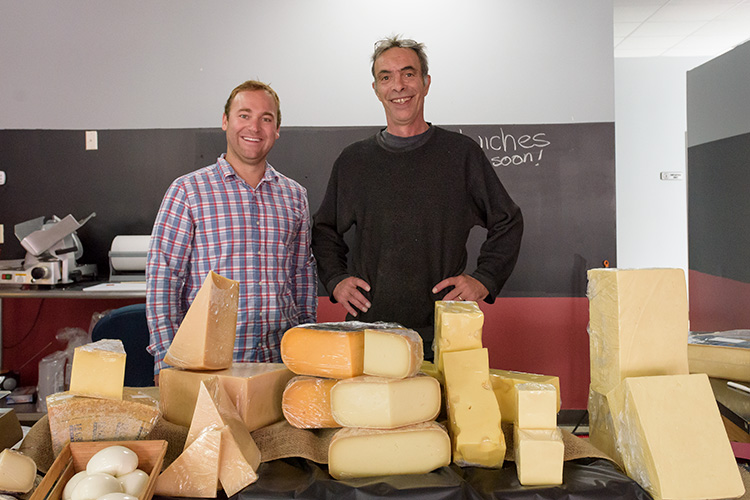 Saline Main Street executive director Riley Hollenbaugh with Cheese Shop of Saline owner John Loomis.