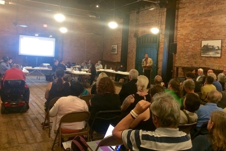 International Village project manager Wayne Hofmann speaks at Tuesday night's meeting.