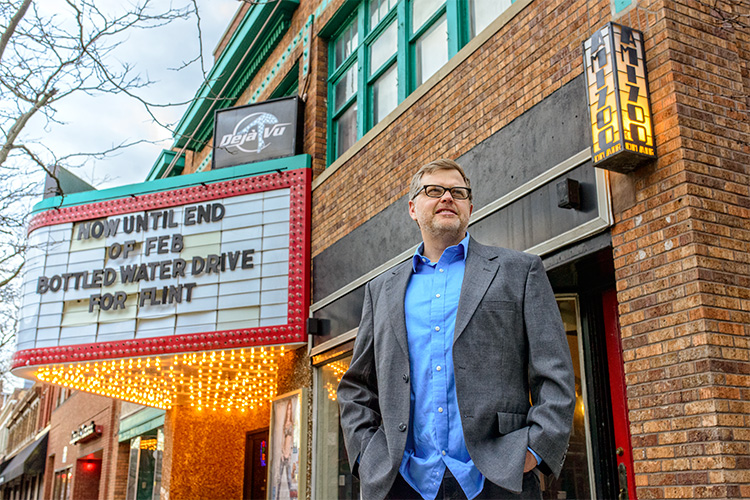 Mark Maynard stands in front of Deja Vu.