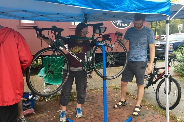 Ypsi Bike Co-Op founders Georgina Hickey and Nathan Voght work on Voght's bike.