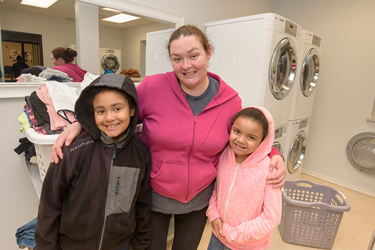 Michelle Metro with daughters Rochelle and Roslyn Robinson at Hope Clinic's Wash With Care laundry program