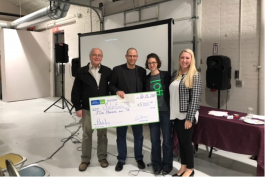 Solartonic cofounders Harry Giles and Brian Tell receive their $5,000 check from Ypsi mayor Amanda Edmonds and Mallory A. Field of Varnum Law.