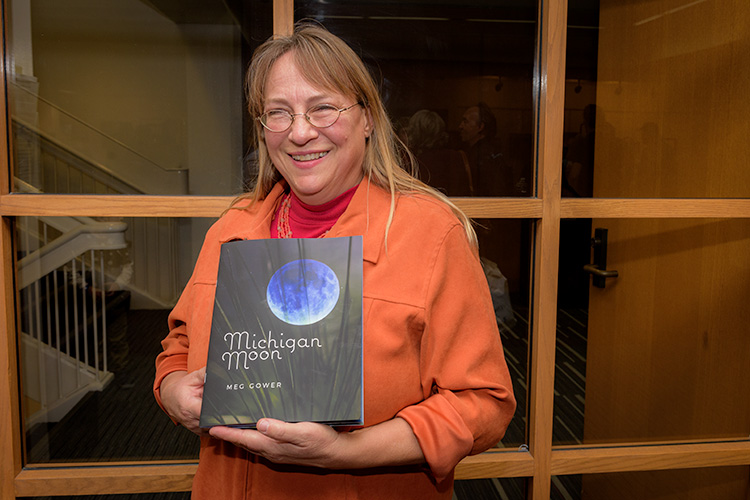 Fifth Avenue Press author Meg Gower with her book "Michigan Moon."