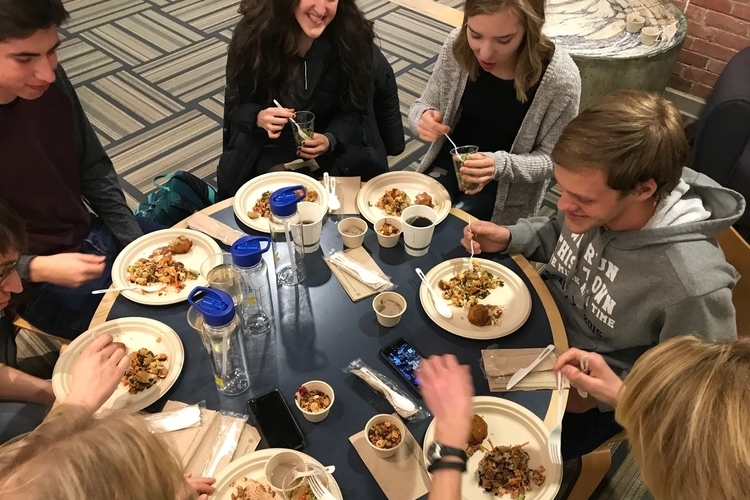 Attendees eat at the waste dinner.