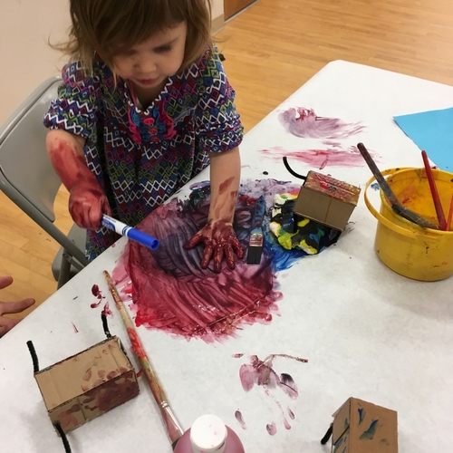 A young visitor does an art activity at Riverside Arts Center.