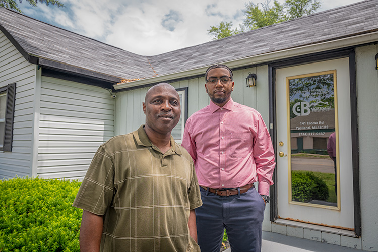 Clyde Montgomery and son Brandan outside of C&B Mortgage Solutions on Ecorse Road