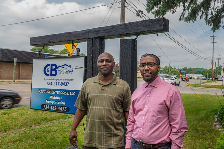 Clyde Montgomery and son Brandan outside of C&B Mortgage Solutions on Ecorse Road