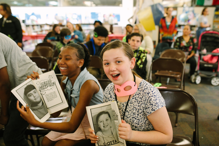 Unique Barne and Hailey Jackson hold their copies of In the Clouds Over Ypsilanti.