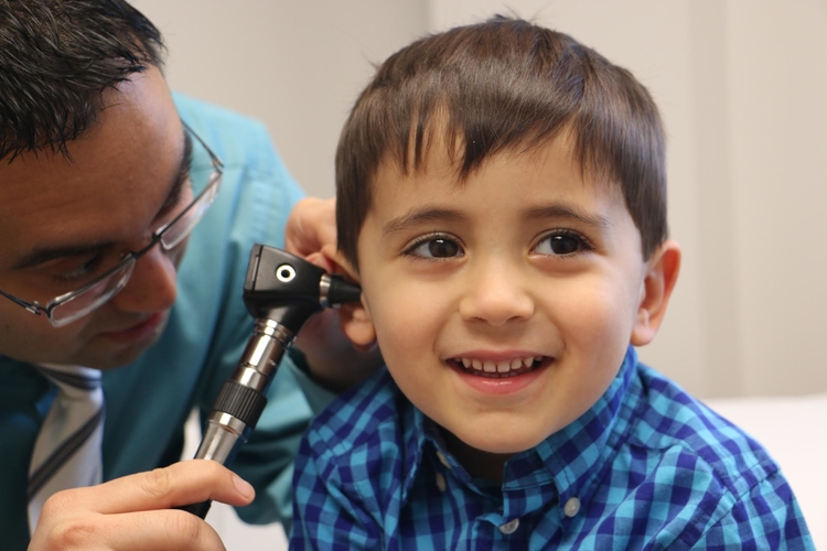 A practitioner examines his son at last year's Healthy Kids Fair.