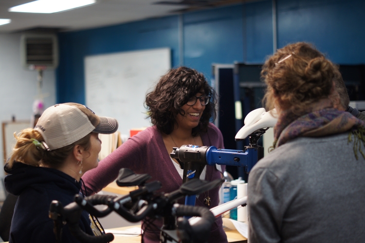 Common Cycle staff help visitors at a bicycle repair clinic.