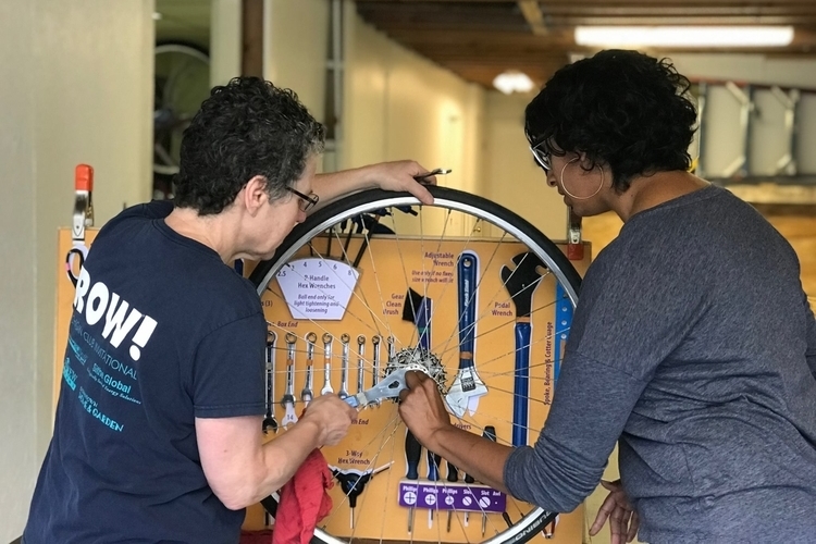 Common Cycle staff help visitors at a bicycle repair clinic.