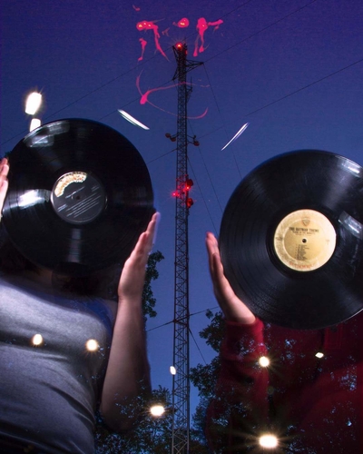 WCBN staffers hold up records in front of their new transmitter.