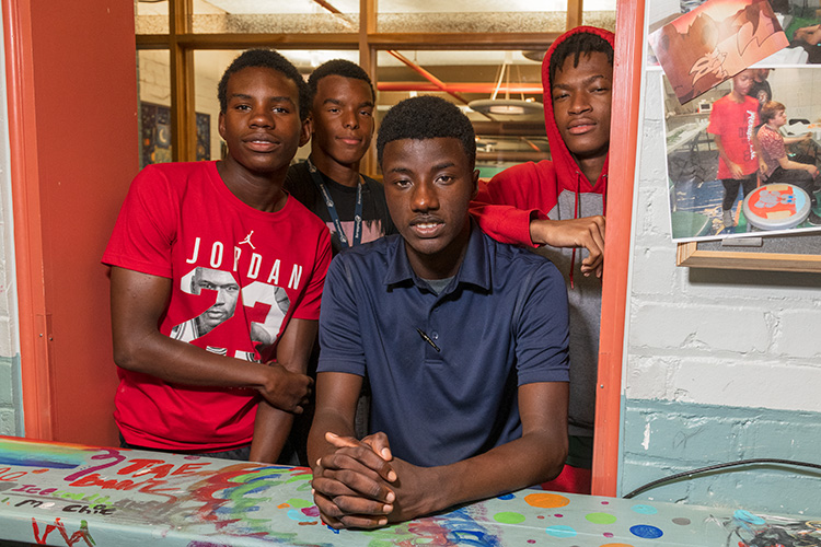 Mentor2Youth participant Charles Green with friends at the downtown Ypsilanti District Library