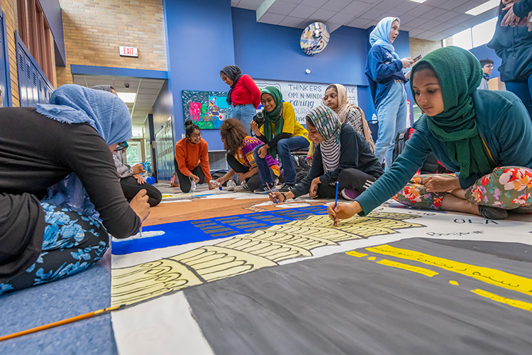 WiHi's Muslim Student Association painting a mural for WiHi's 8th International Dinner