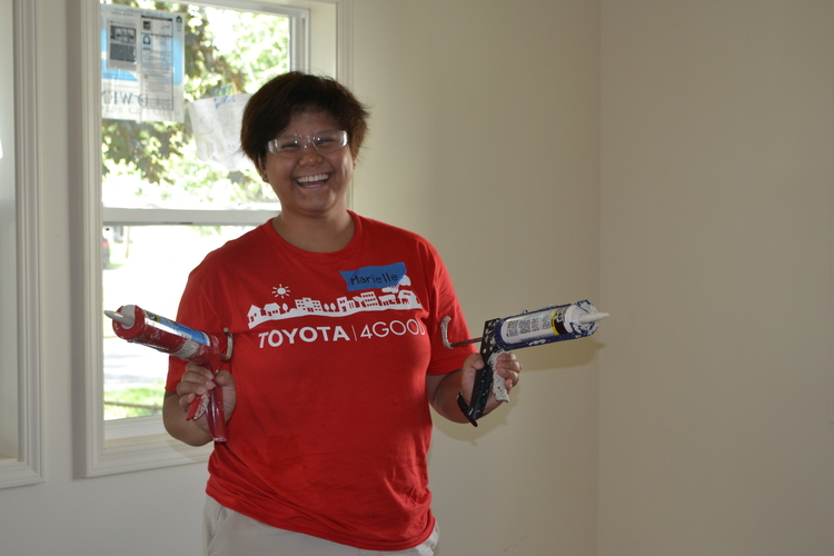 A Toyota volunteer works on a Habitat for Humanity house in Ypsi Township.