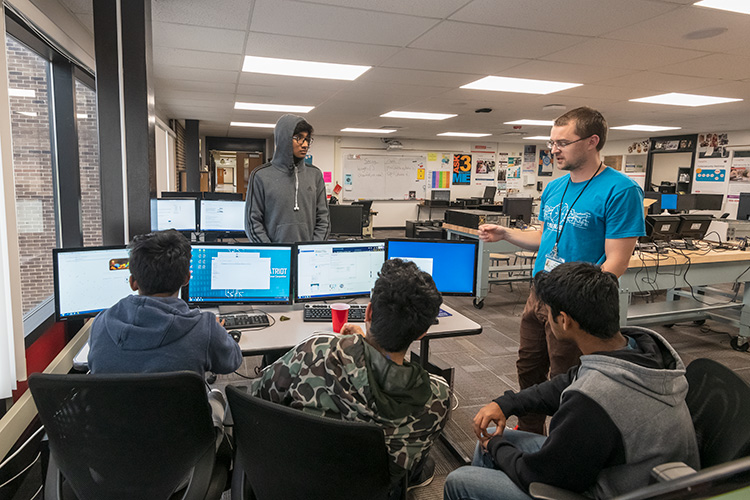 Teacher Scott Obsniuk advises students with the Canton High School CyberPatriots