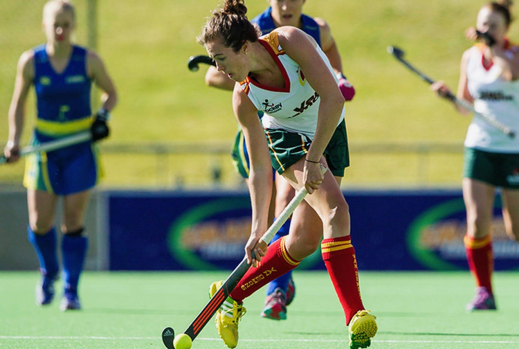 Uru founder Ainsley McCallister playing field hockey for the Tasmania Van Demons.