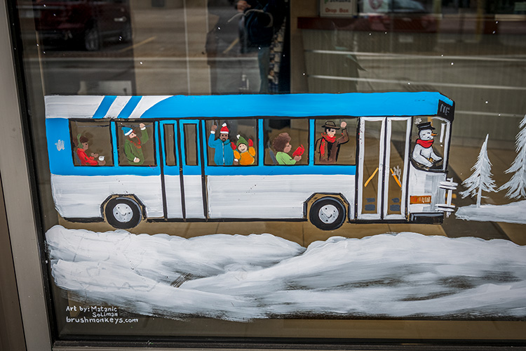 A Brush Monkeys holiday window painting at the Blake Transit Center