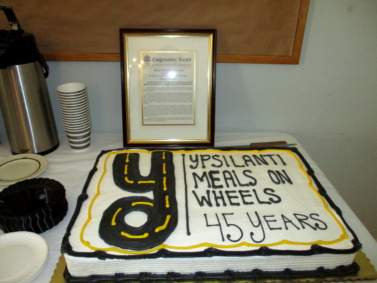 A birthday cake and proclamation from U.S. Rep. Debbie Dingell celebrating YMOW's anniversary.