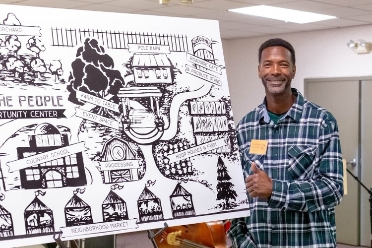 Melvin Parson shows off a concept drawing of We the People Opportunity Center.